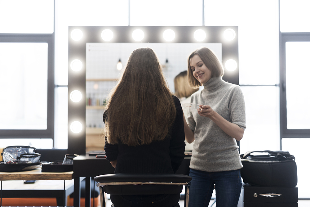 cheerful-stylist-applying-makeup-anonymous-woman cheerful-stylist-applying-makeup-anonymous-woman